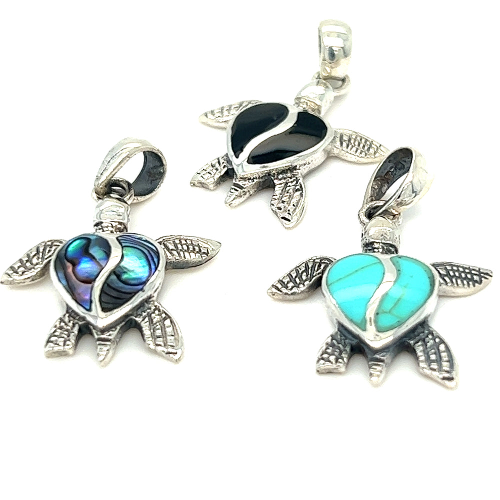 
                  
                    Three Stone Inlay Turtle Pendants in sterling silver with turquoise stones.
                  
                