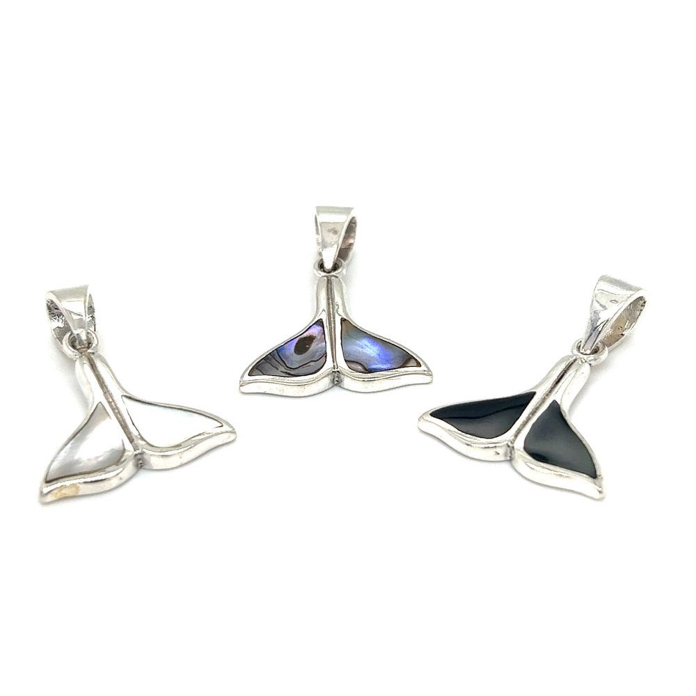 
                  
                    Three Simple Whale Tail Pendants with Inlay Stones by Super Silver on a white background.
                  
                