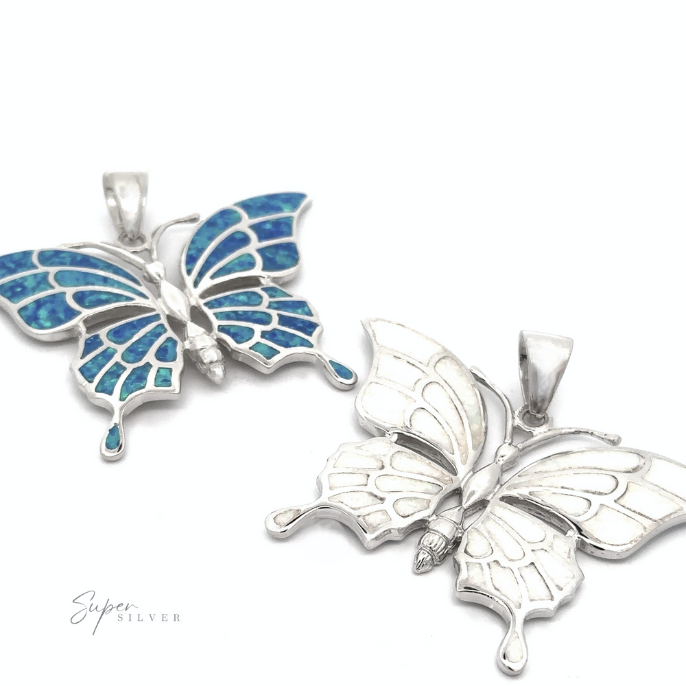 
                  
                    Two "Statement Lab-Created Opal Butterfly Pendants" in sterling silver are displayed. One pendant features blue enamel detailing, while the other is plain silver. The logo "Super Silver" is visible in the bottom left corner.
                  
                