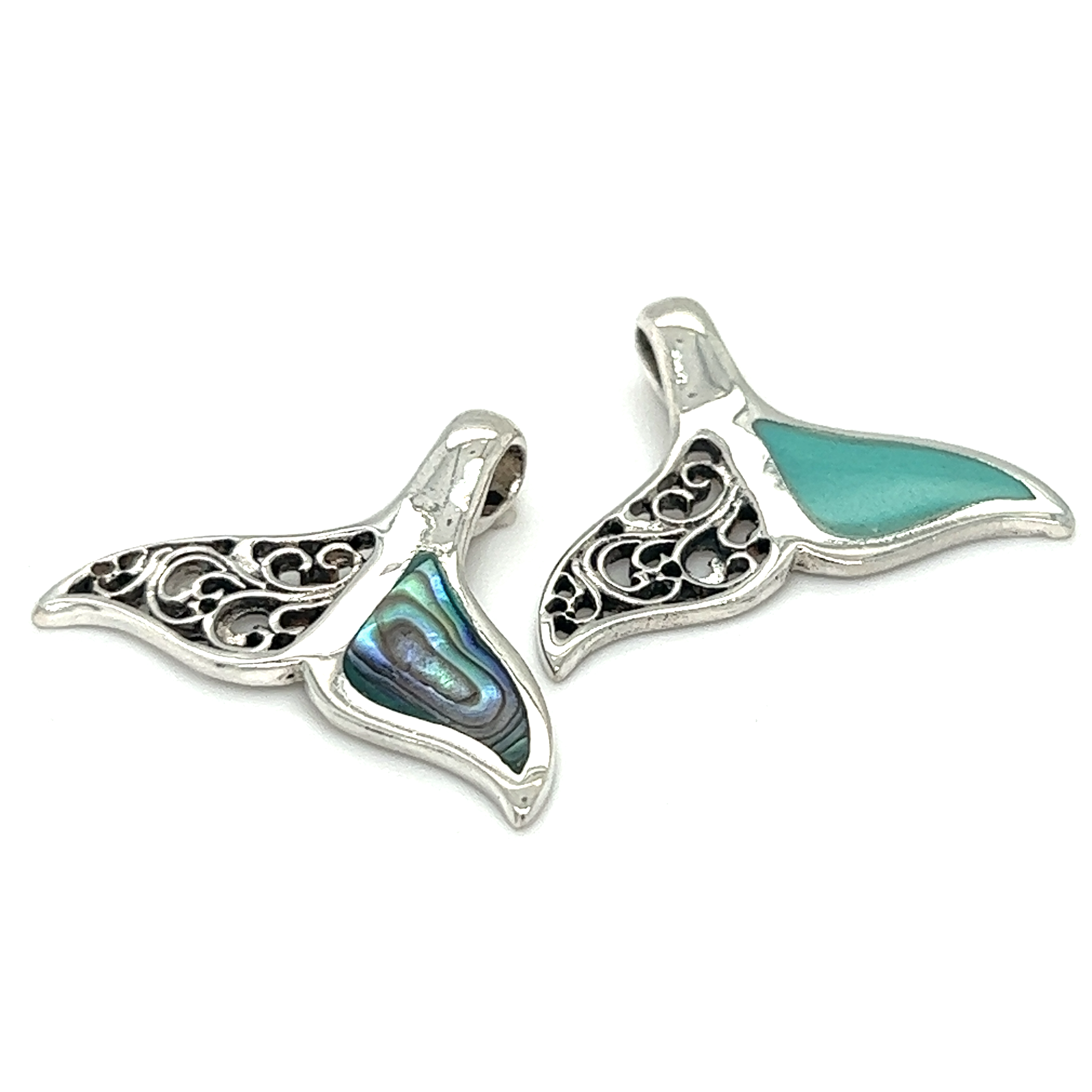 Two Half Filigree Whale Tail Pendants showcasing ocean conservation on a white background.