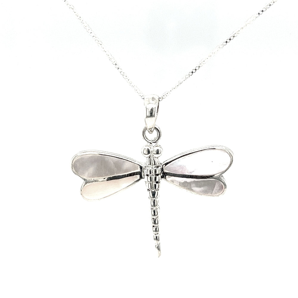 
                  
                    A stunning Super Silver Dragonfly Inlay Stone pendant adorned with intricate mother of pearl detailing, elegantly hanging from a delicate chain.
                  
                