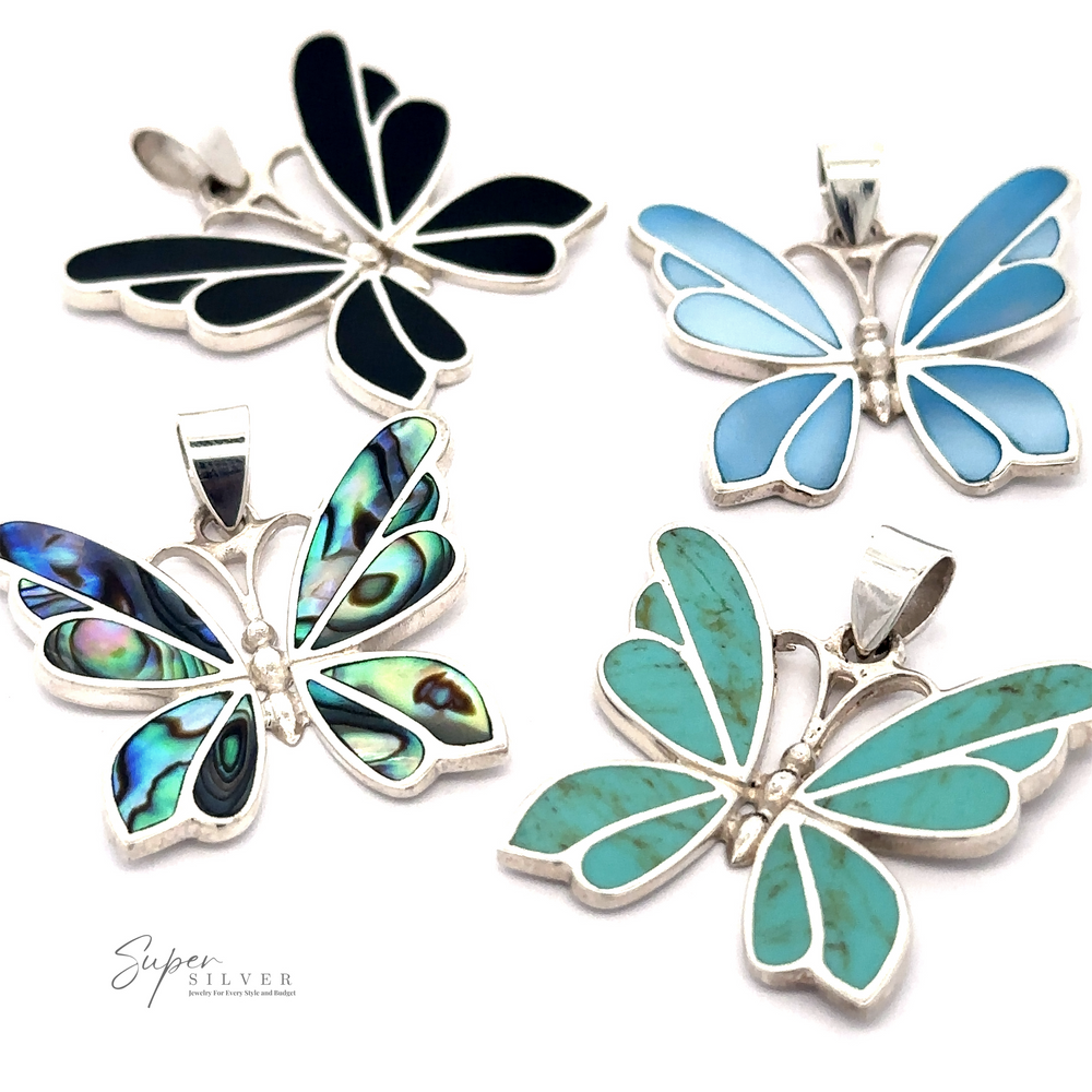 Four Medium Inlay Butterfly Pendants with different colored inlays (black, blue, abalone, and turquoise) on a white background. The brand "Super Silver" is noted in the lower left corner. These exquisite gemstone pendants add a touch of elegance to any collection.