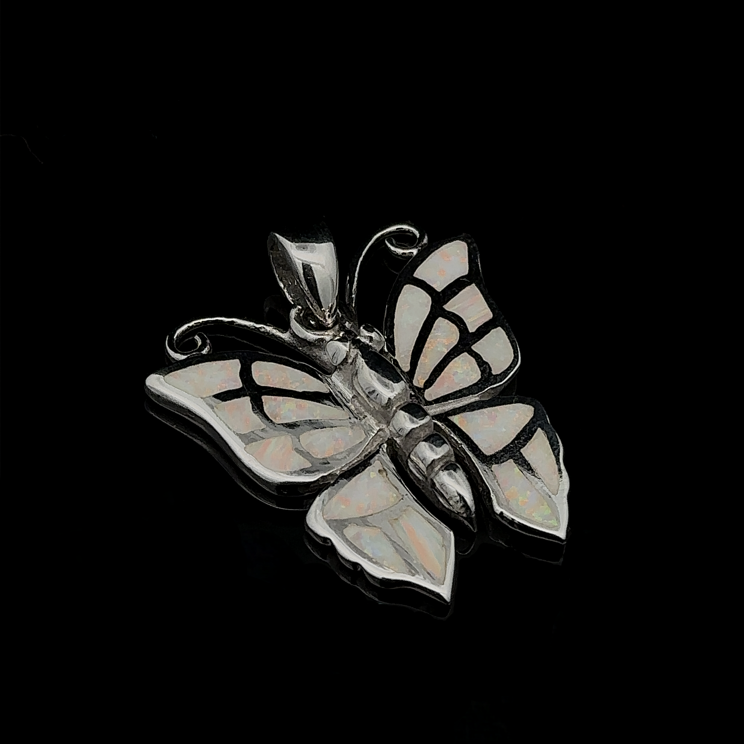 Lab-Created Opal Butterfly Pendant featuring a sterling silver butterfly adorned with lab-created opal inlays against a black background.