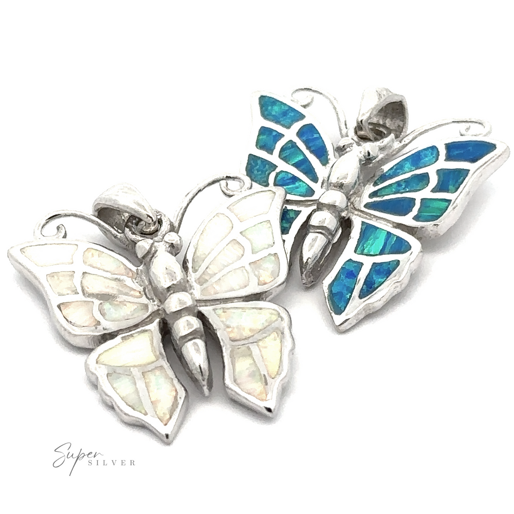 
                  
                    The Lab-Created Opal Butterfly Pendants are crafted in sterling silver and feature intricate inlay designs. One pendant showcases white lab-created opal wings, offering a translucent beauty, while the other dazzles with vibrant blue and green hues.
                  
                