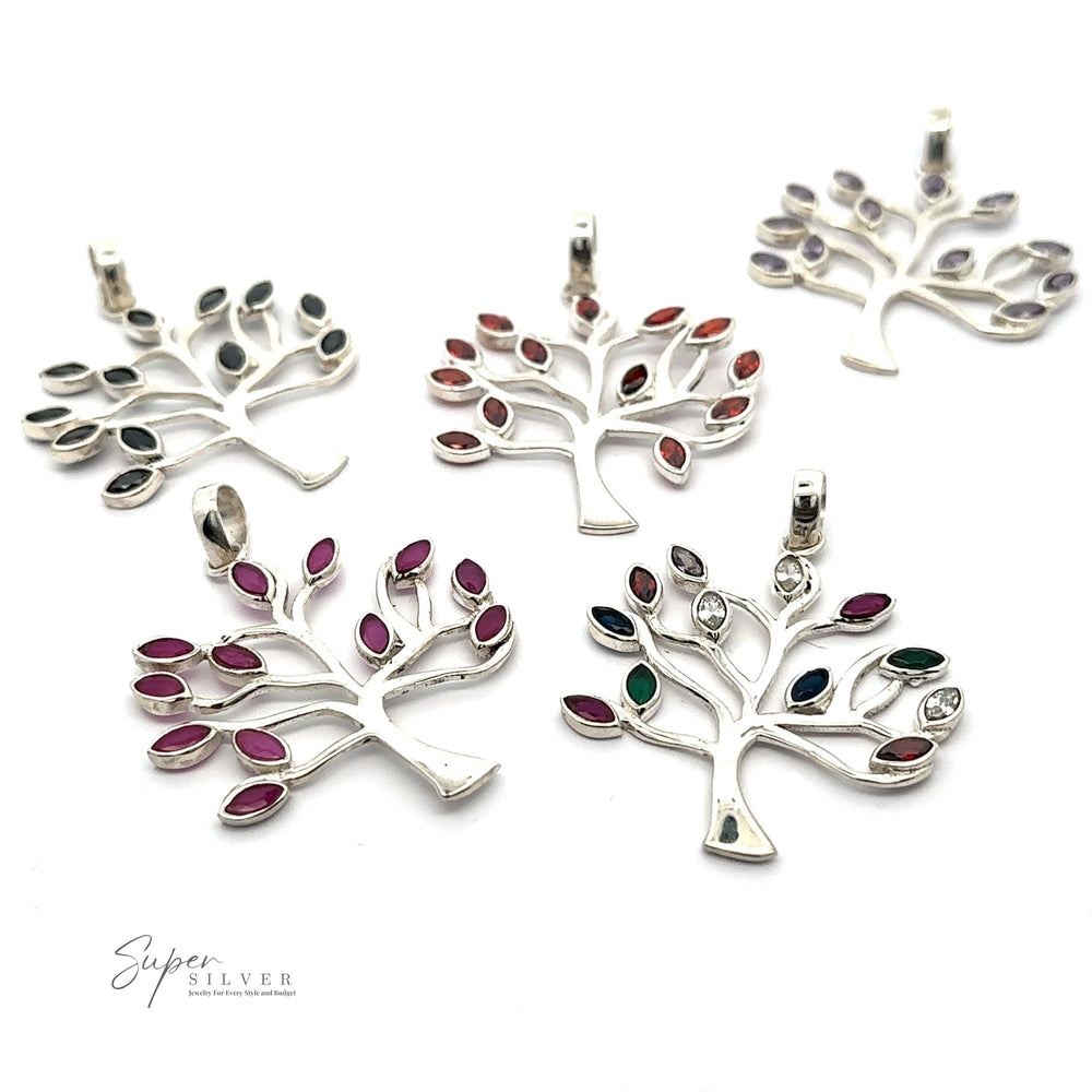 Five Tree of Life Pendant with Stone Leaves are displayed on a white background.