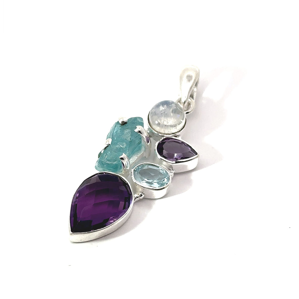 
                  
                    The Amethyst Multi Stone Pendant is a captivating bohemian jewelry piece, showcasing a striking amethyst teardrop, exquisite blue stones, and a clear gem beautifully set in silver against a white background.
                  
                