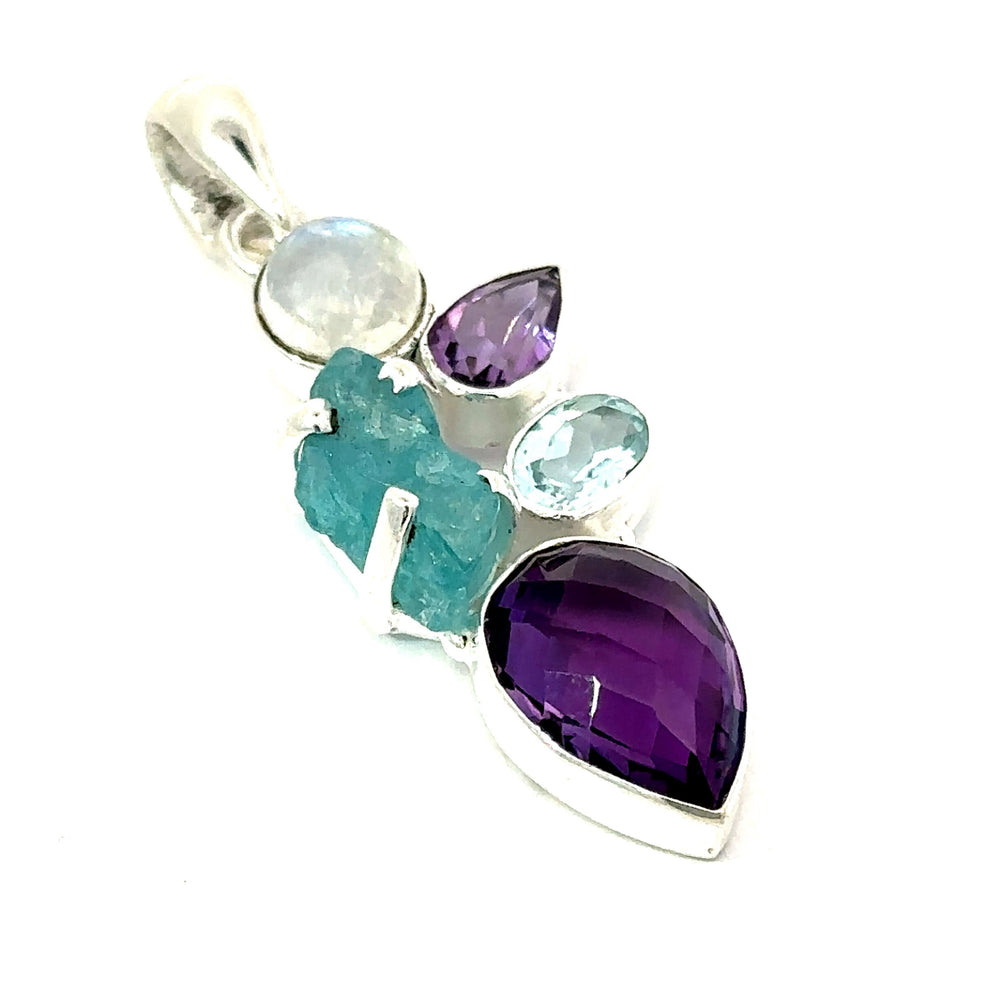 
                  
                    The Amethyst Multi Stone Pendant is a bohemian jewelry piece featuring a striking silver design adorned with a cluster of mixed gemstones, including amethyst tones and blue and turquoise stones in various shapes and sizes.
                  
                