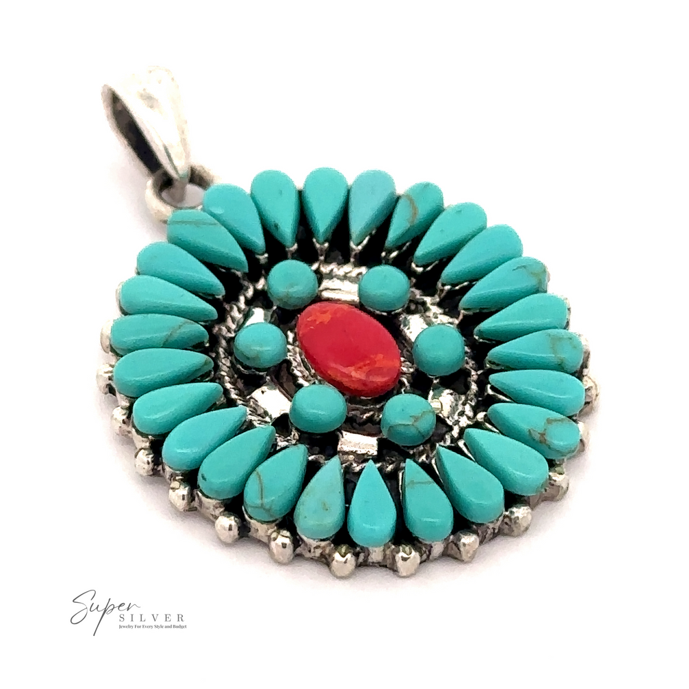 A circular silver pendant, in a Native American-inspired design, features an arrangement of turquoise stones with a single red stone at the center. This Navajo needlepoint style piece is labeled "Turquoise Pendant With Coral Center.