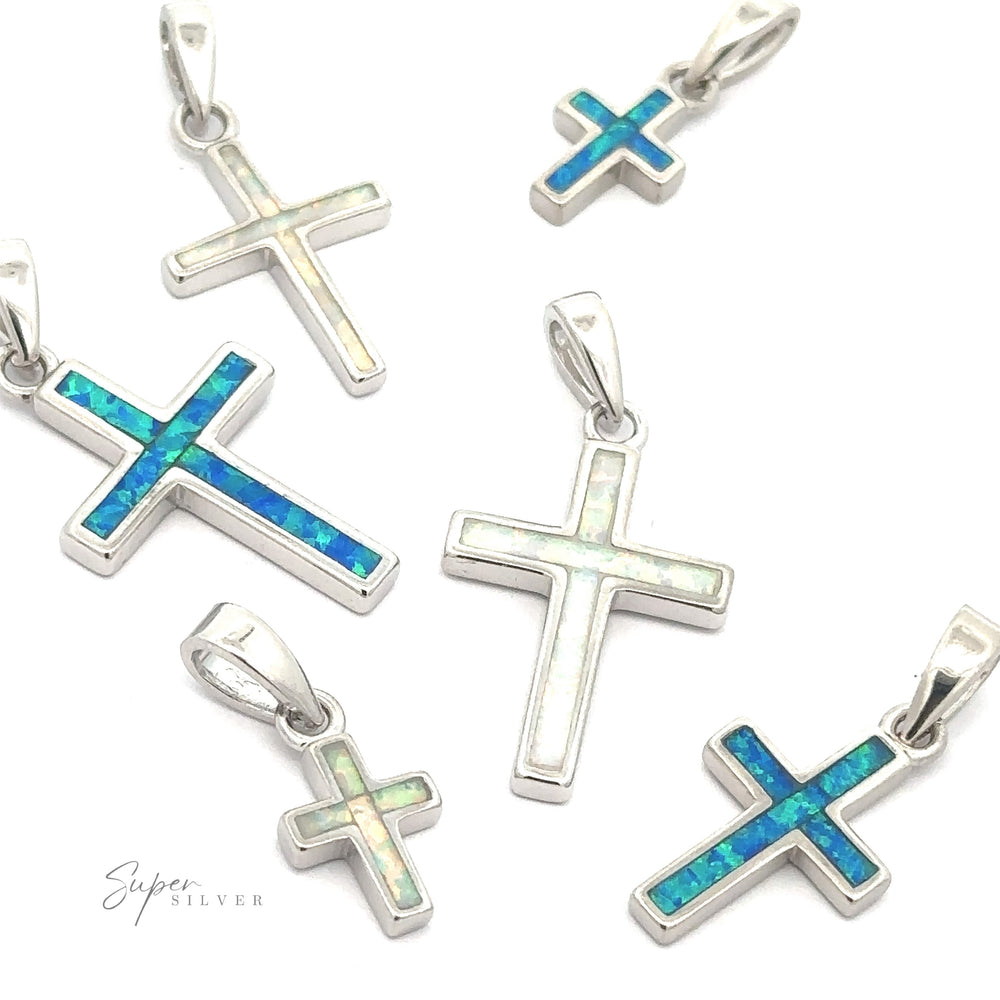 
                  
                    The Lab-Created Opal Cross Pendants are crafted from sterling silver and showcase an array of sizes and colors, beautifully presented on a white background.
                  
                