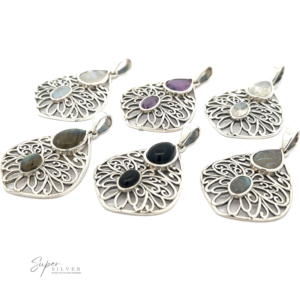 
                  
                    Six intricately designed Teardrop Filigree Gemstone Pendants with various gemstones are arranged on a white background. The gemstones include shades of white, purple, and black, featuring stunning amethyst and onyx pendants.
                  
                