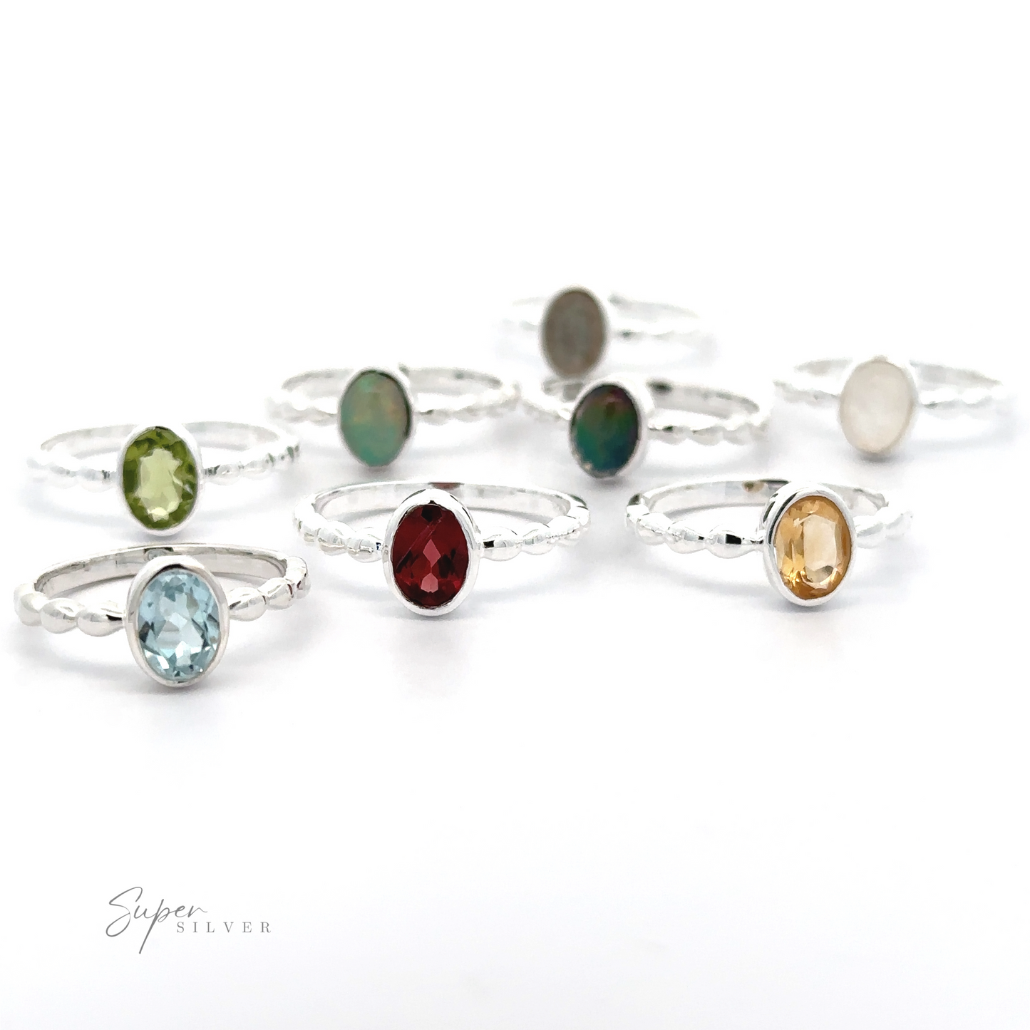 A collection of Oval Gemstone Rings with Beaded Bands displayed on a white background.
