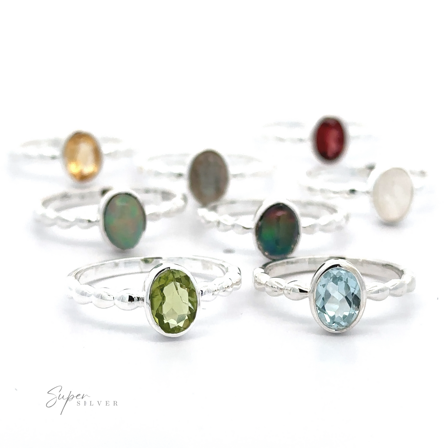 
                  
                    A collection of Oval Gemstone Rings with Beaded Bands displayed on a white background.
                  
                