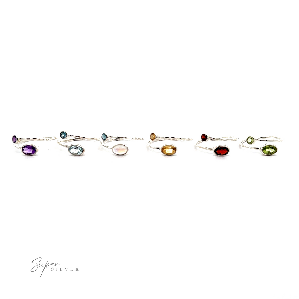 
                  
                    A collection of seven Textured Adjustable Bands with Adorned Gemstones, each featuring a different color gemstone, displayed in a row against a white background.
                  
                