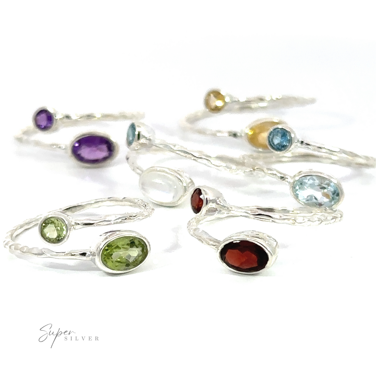 Assorted Textured Adjustable Bands with Adorned Gemstones, displayed against a white background, feature adjustable gemstone settings.
