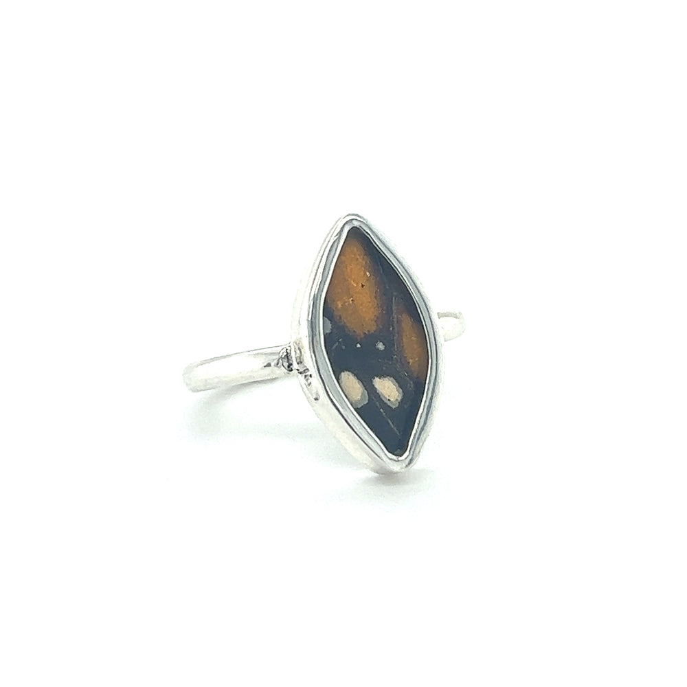 
                  
                    A sustainable fashion Genuine Butterfly Wing ring in Marquise Shape with a black and brown stone.
                  
                