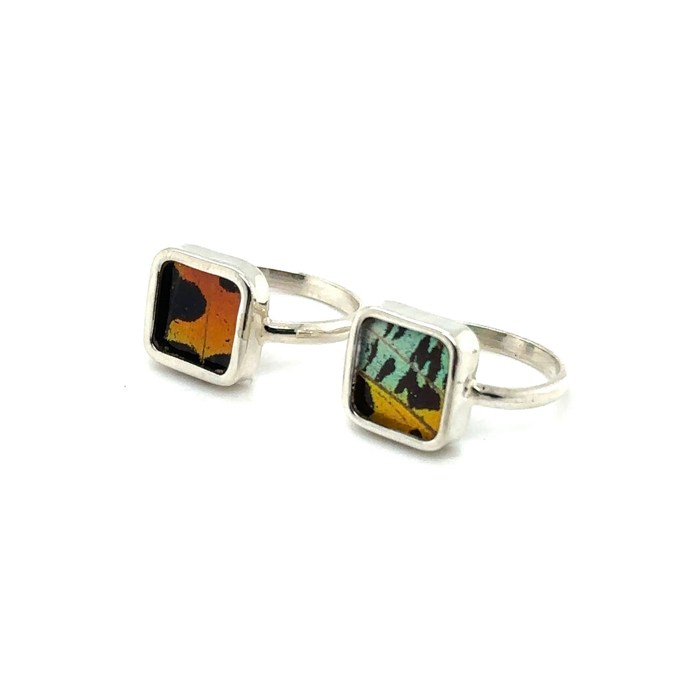 A pair of square sterling silver Genuine Butterfly Wing Rings in Square Shape with multi colored glass, inspired by the design found in the Peruvian Amazon.