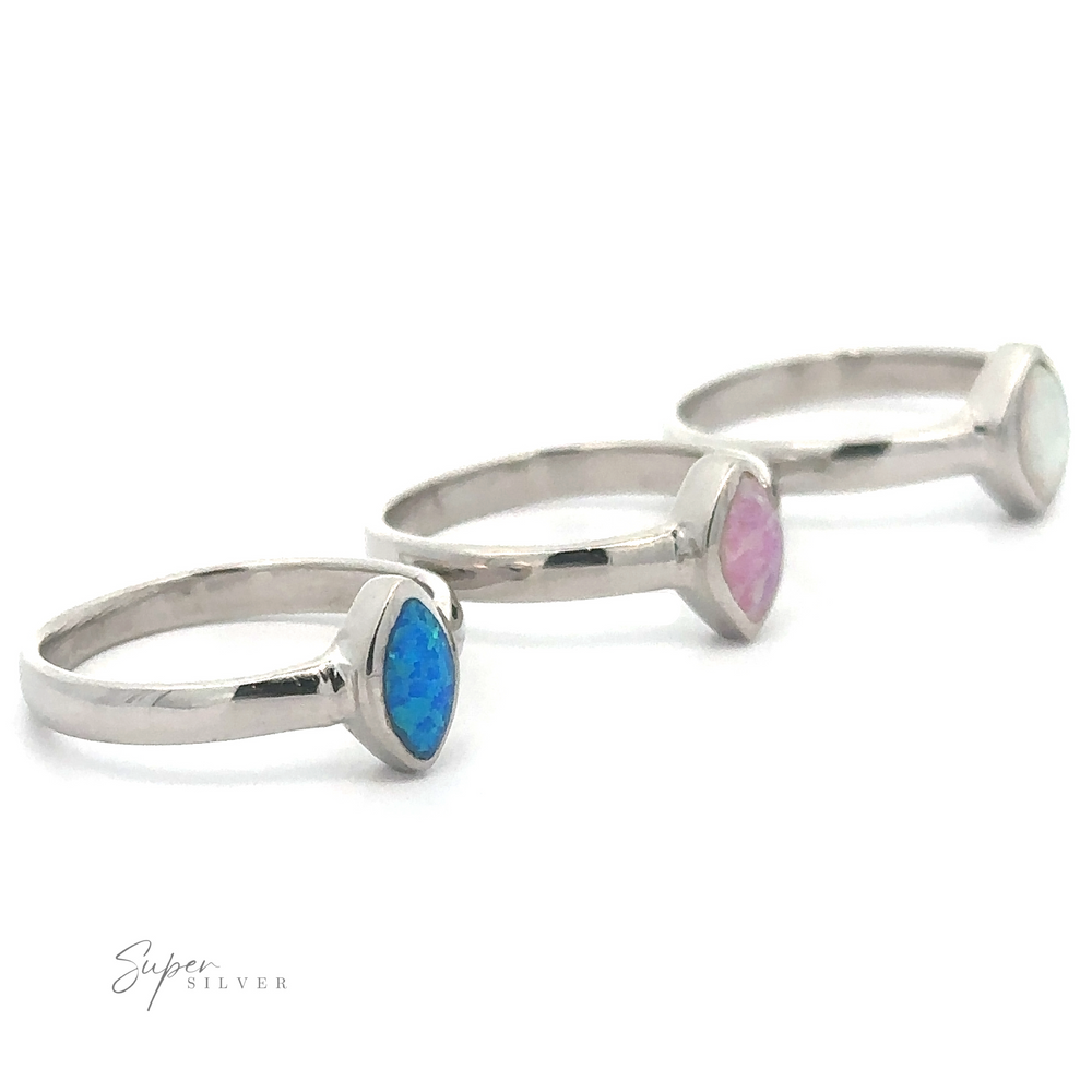 Three Simple Marquise Shaped Opal Rings displayed in a row against a white background.