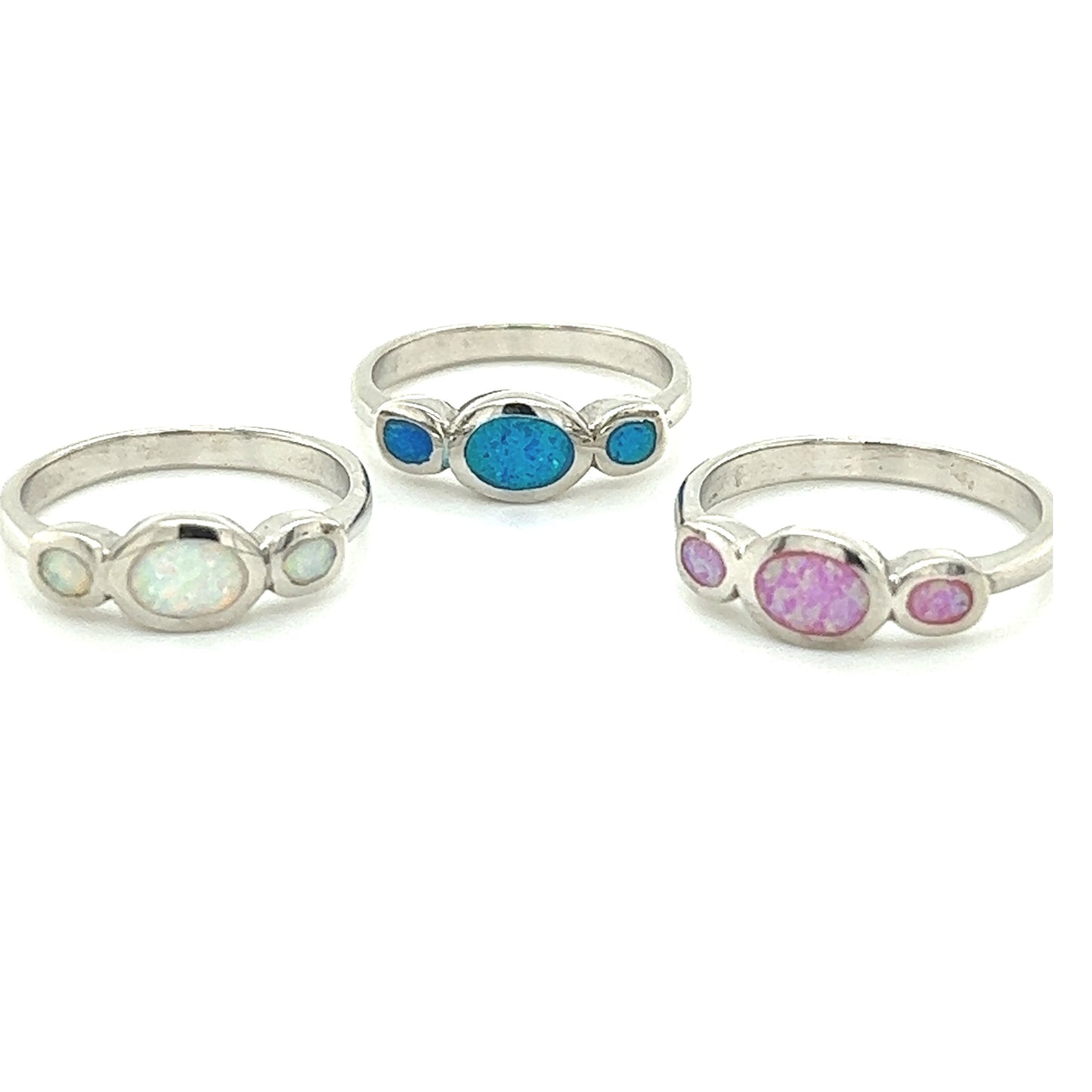 Three Super Silver Triple Oval Opal Rings, with blue, pink and white opals, showcasing elegance and a rhodium finish.
