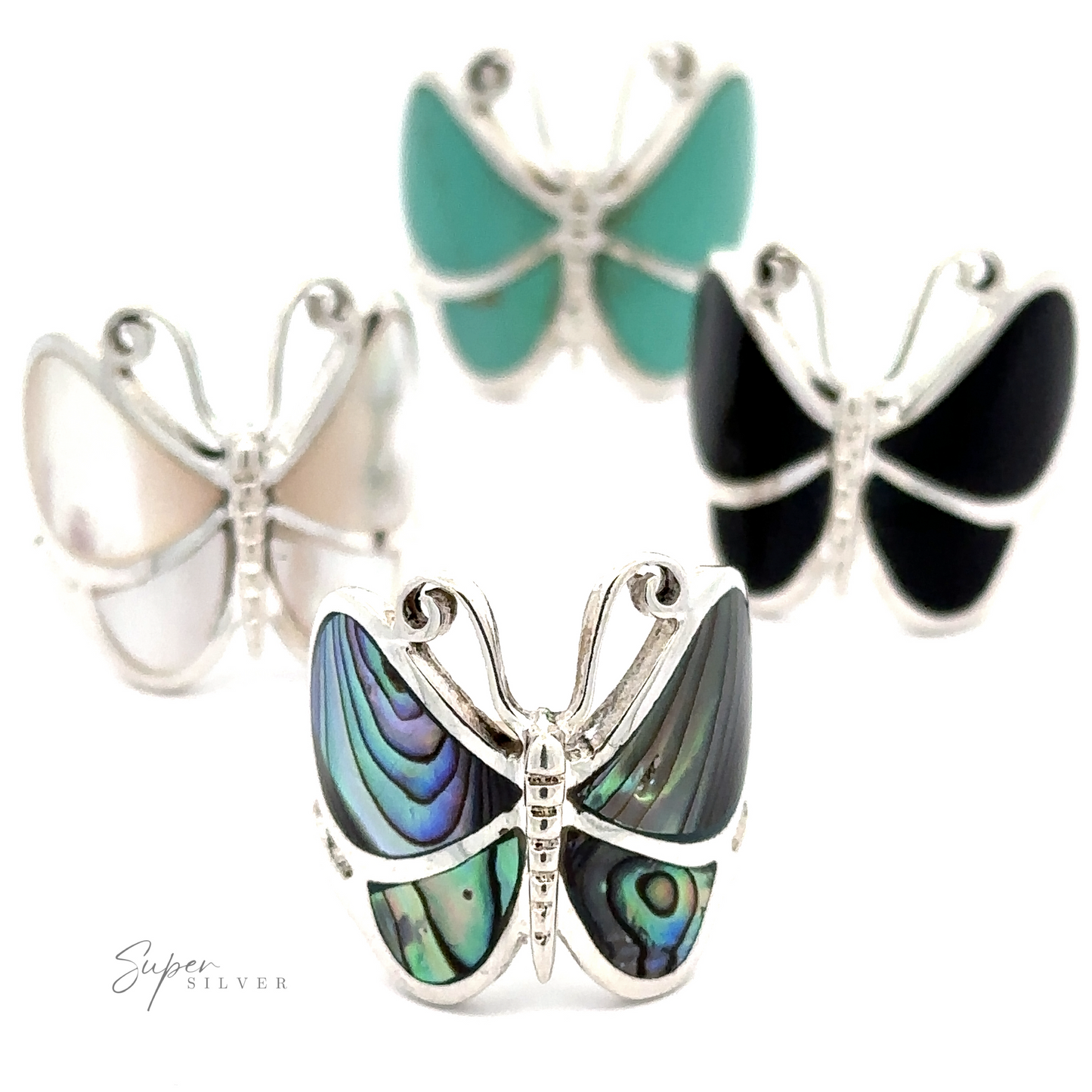 Three Bold Butterfly Rings with Inlaid Stones crafted from sterling silver with inlays in pastel blue, black, and iridescent green displayed against a white background.