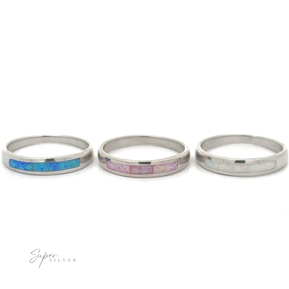 
                  
                    Three Sterling Silver rings with Inlay Opal Half Band stones on a white background.
                  
                