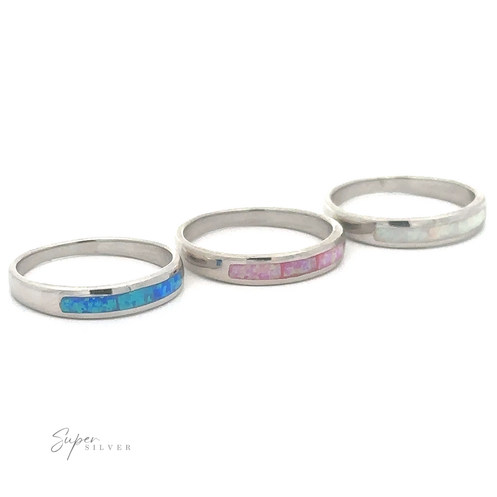 
                  
                    Three opulent charm sterling silver rings with Inlay Opal Half Bands on a white background.
                  
                