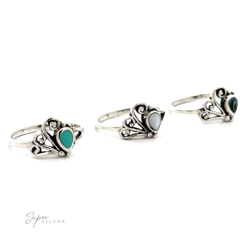 Three silver Inlaid Stone Rings with Freeform Design on a white background.