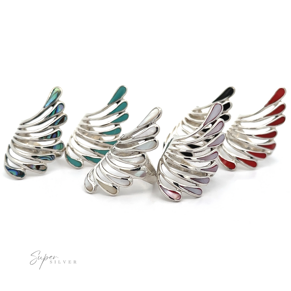Shimmering silver wing cuffs on a white background.