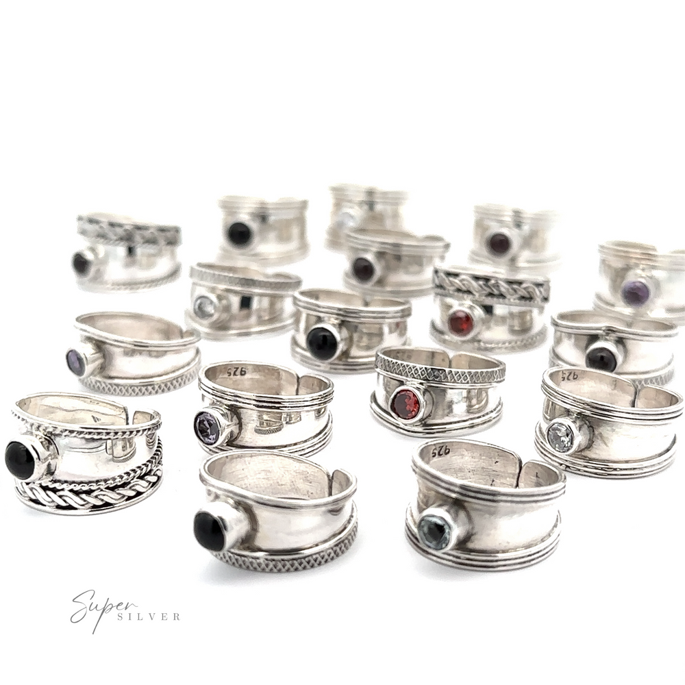 A collection of various Adjustable Wide Cigar Band Toe Rings with Gemstones displayed on a white background.