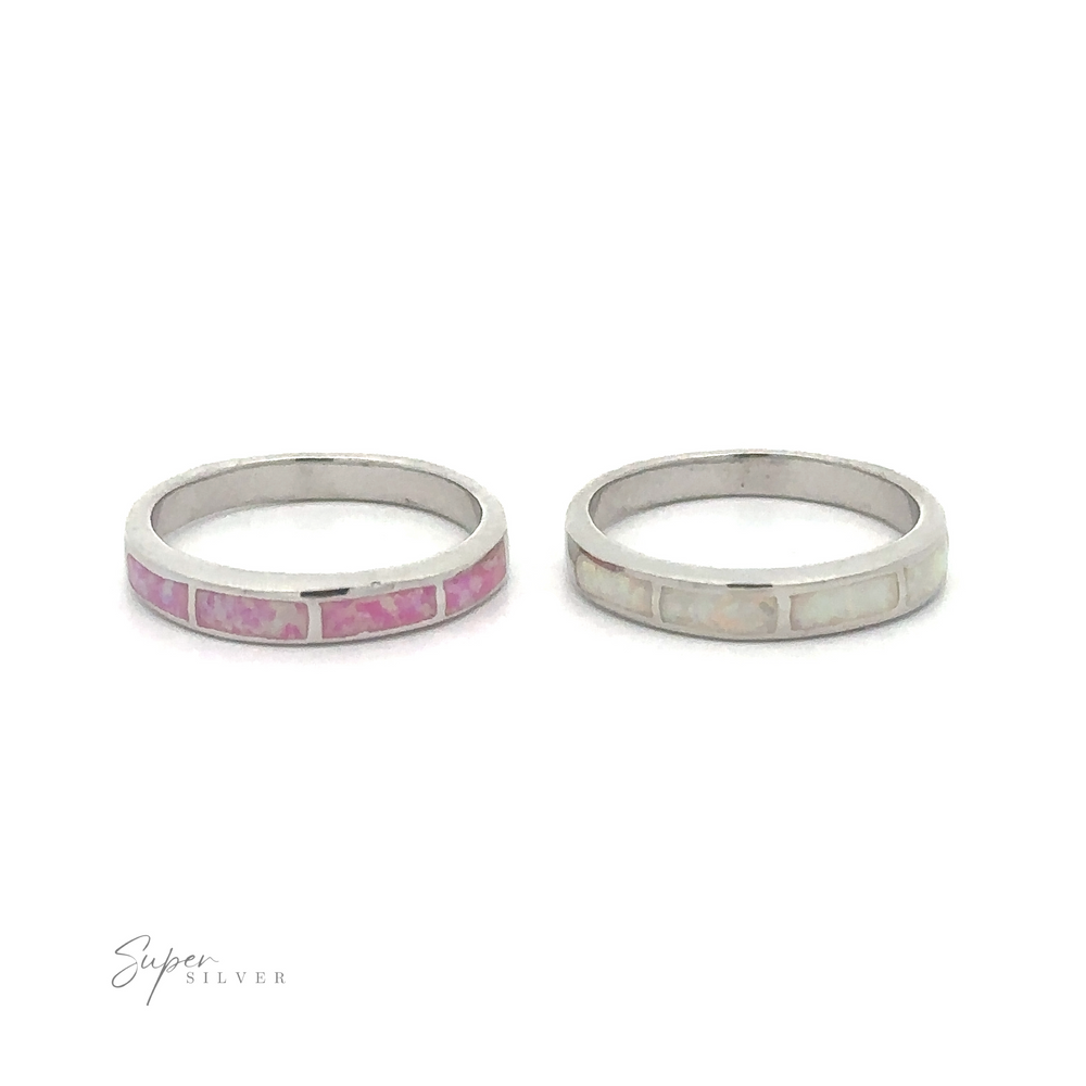 Two minimalist sterling silver rings with Striped Lab Opal Bands and white stones on a white background.