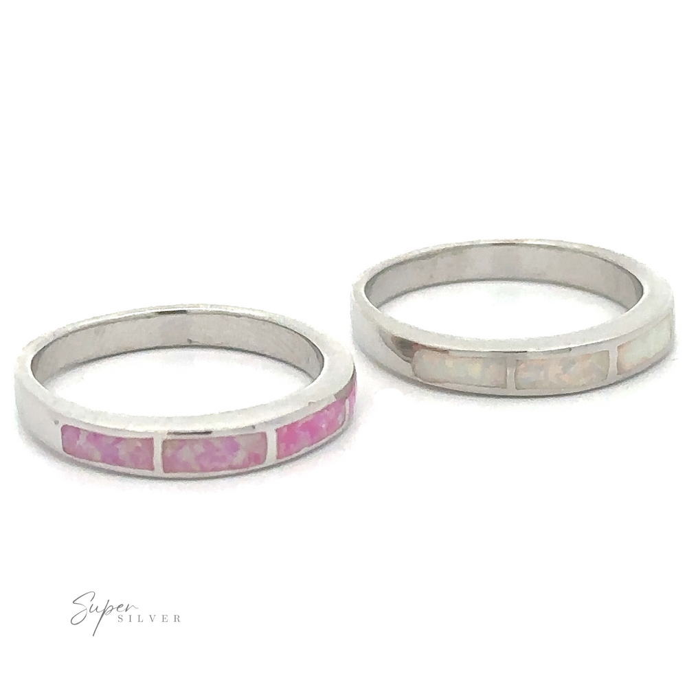 Two minimalist sterling silver rings inlaid with pink and white Striped Lab Opal Bands on a white background.