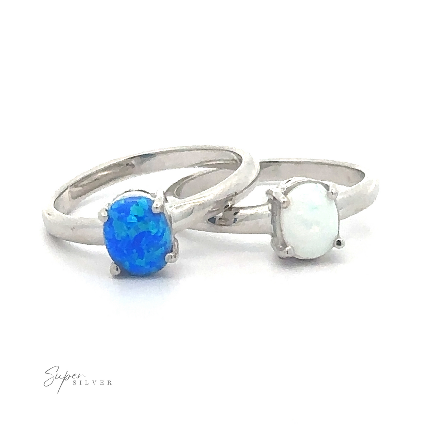 Two Simple Pronged Lab Opal Rings with blue and white oval lab-created opal gemstones on a white background.