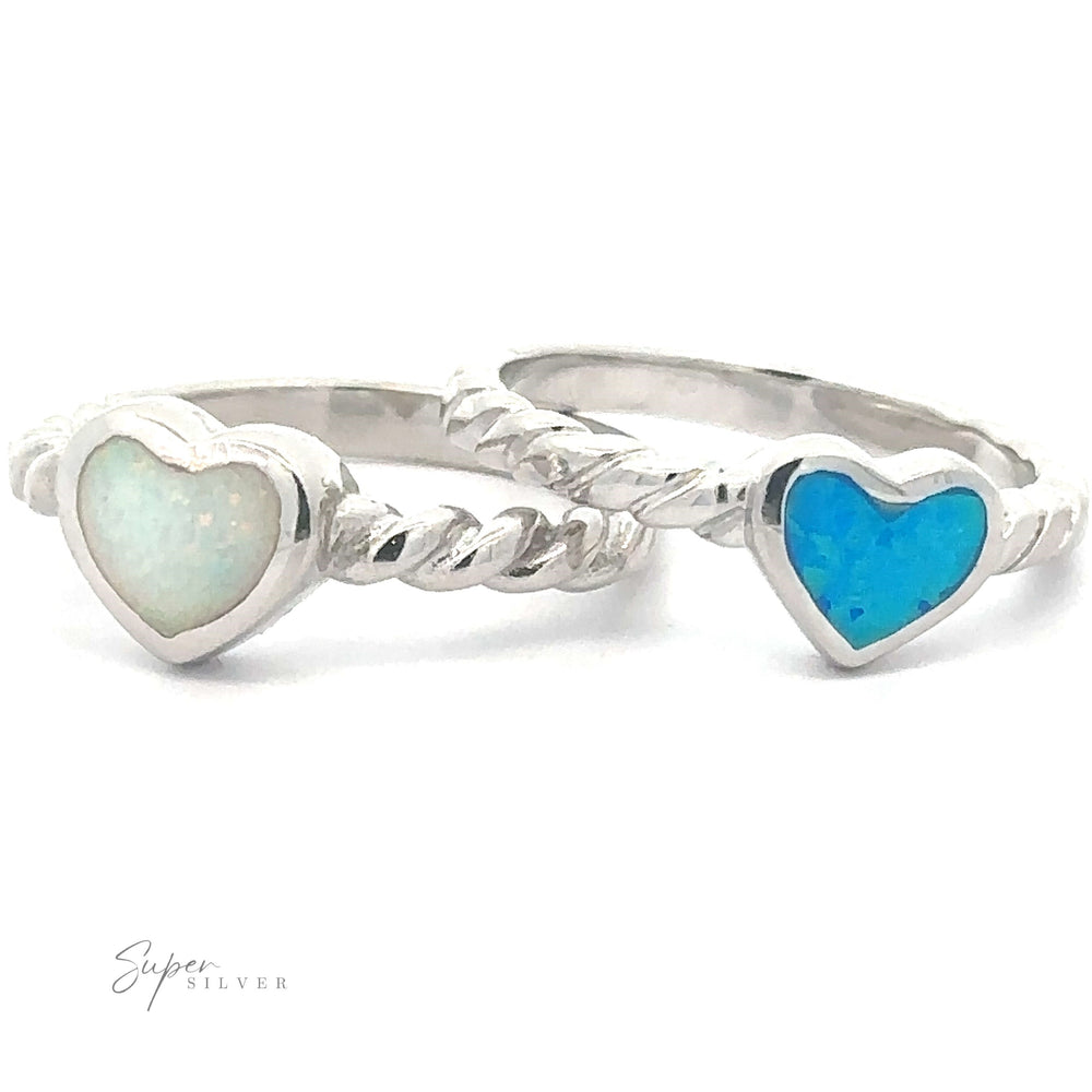 Two Lab Opal Heart Rings with Twisted Band designs on a white background.