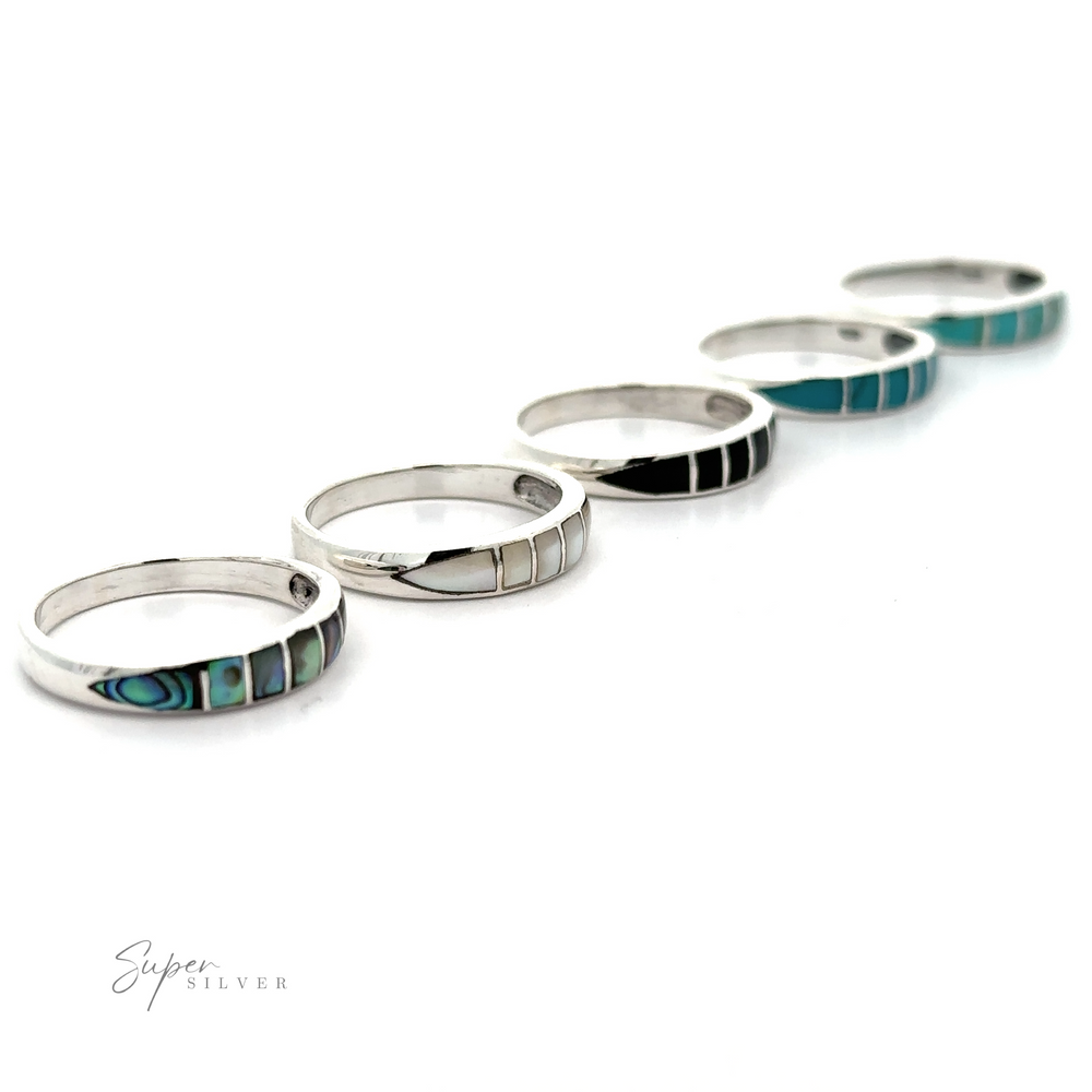 
                  
                    A striking row of sterling silver stacking Inlay Stone Bands with turquoise inlays.
                  
                