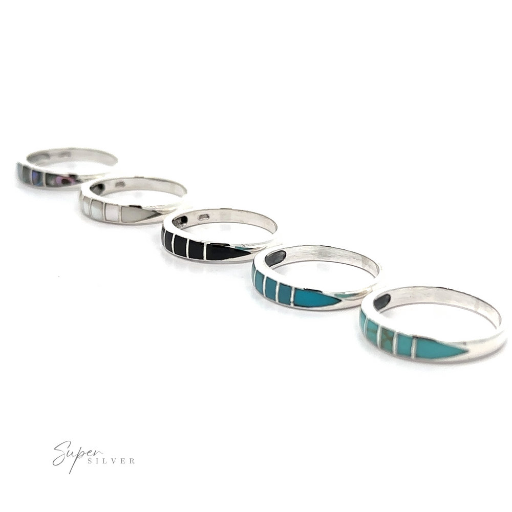 A row of sterling silver Inlay Stone Bands with turquoise inlays.