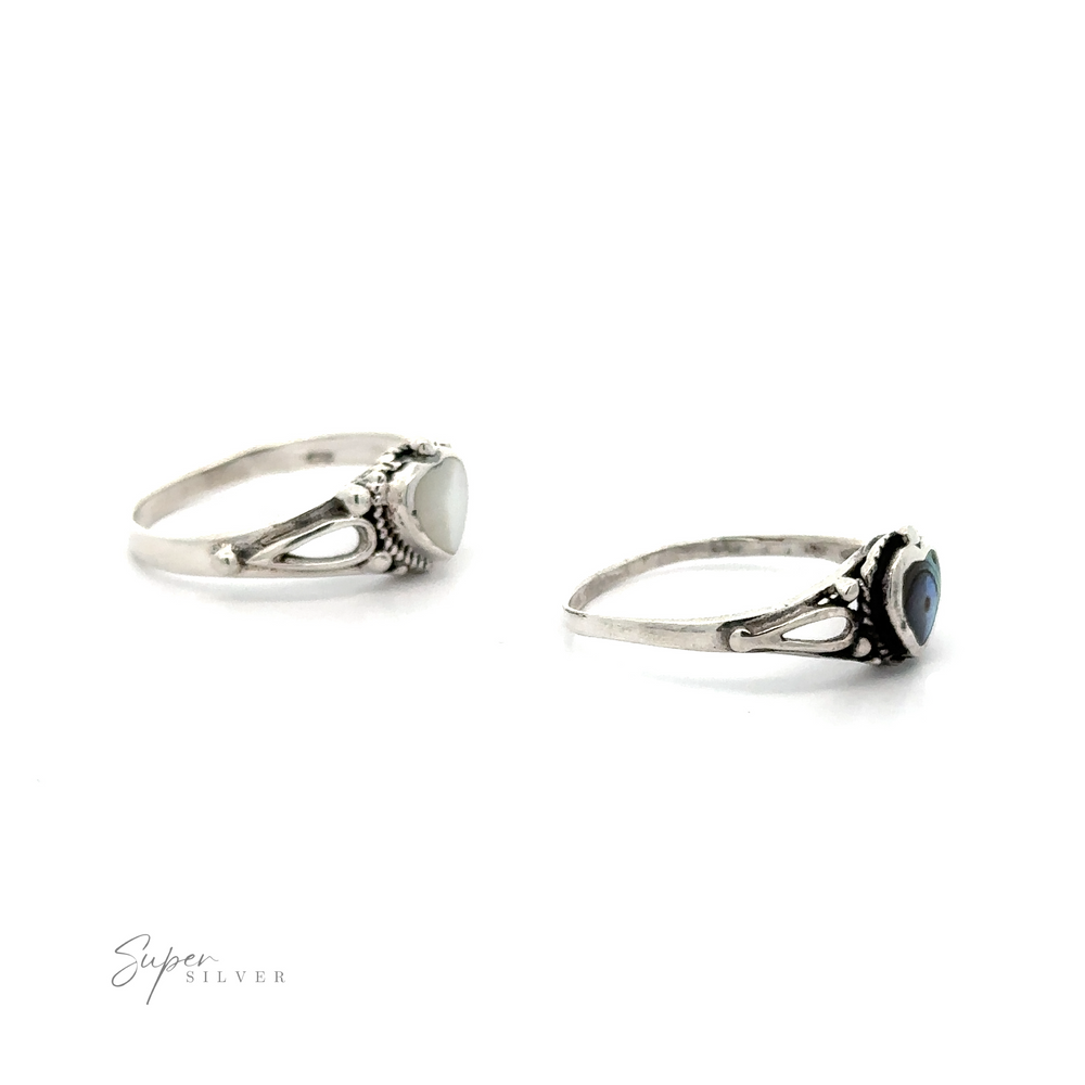 
                  
                    Two silver rings with Inlaid Stone Heart Rings on a white background.
                  
                