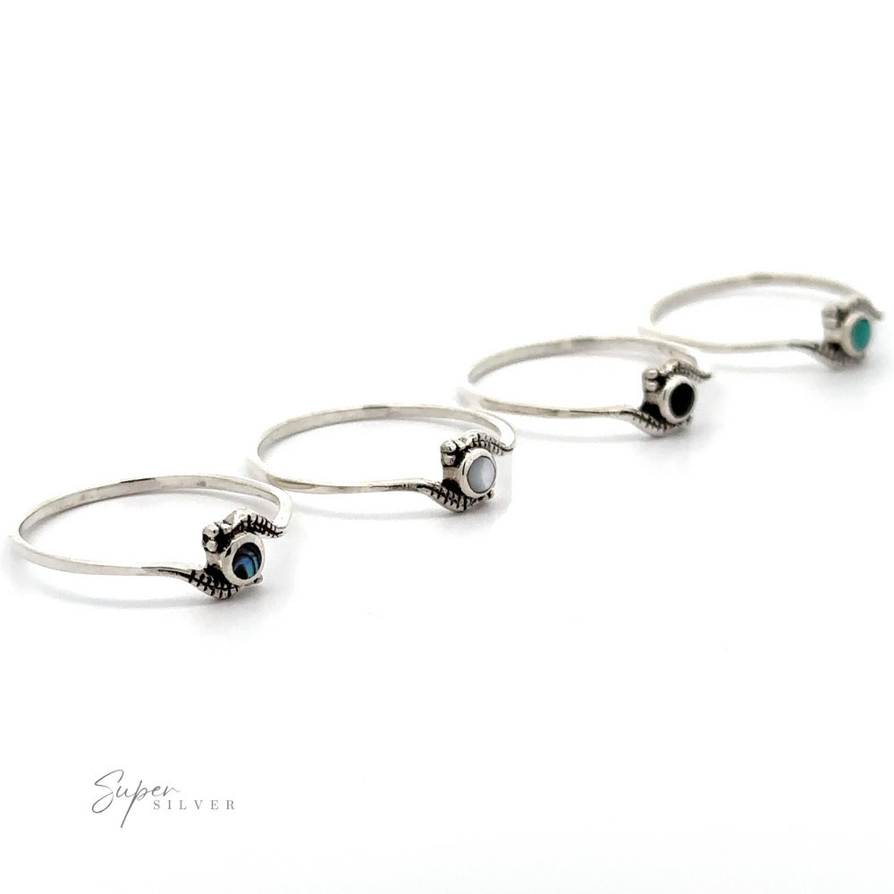 Three silver Tiny Freeform Rings with turquoise evil eye charms on a white background.