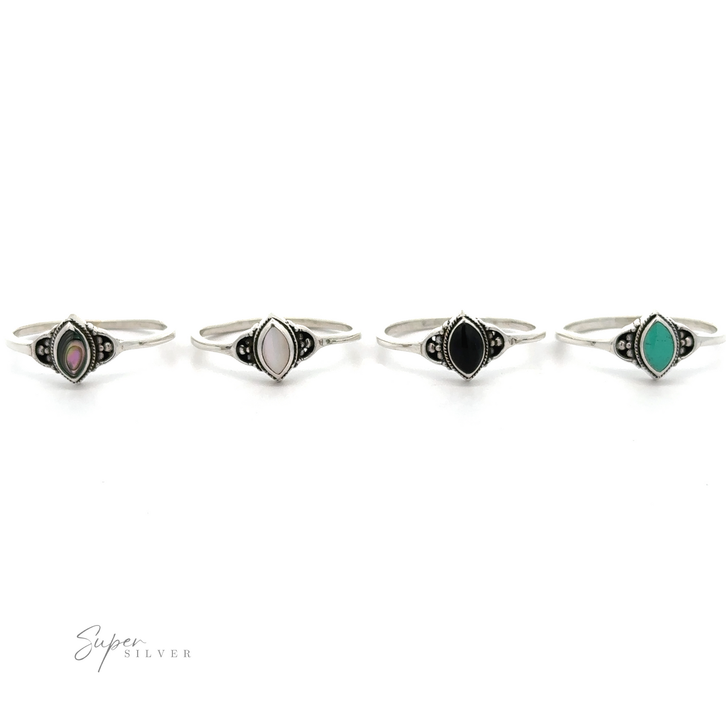 
                  
                    Four Delicate Marquise Inlaid Stone Rings with inlaid black, green, and blue stones.
                  
                
