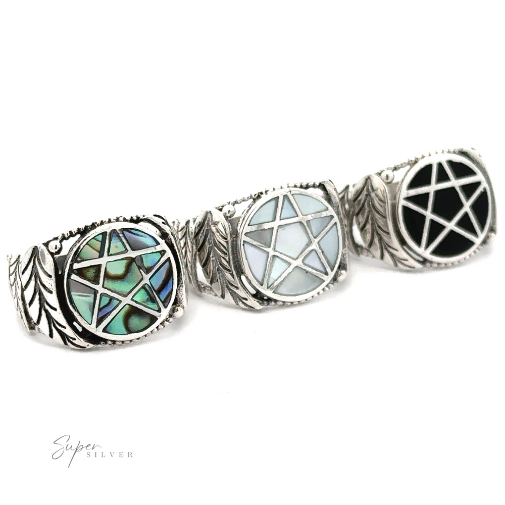 Pentagram ring with inlaid stones featuring star patterns.