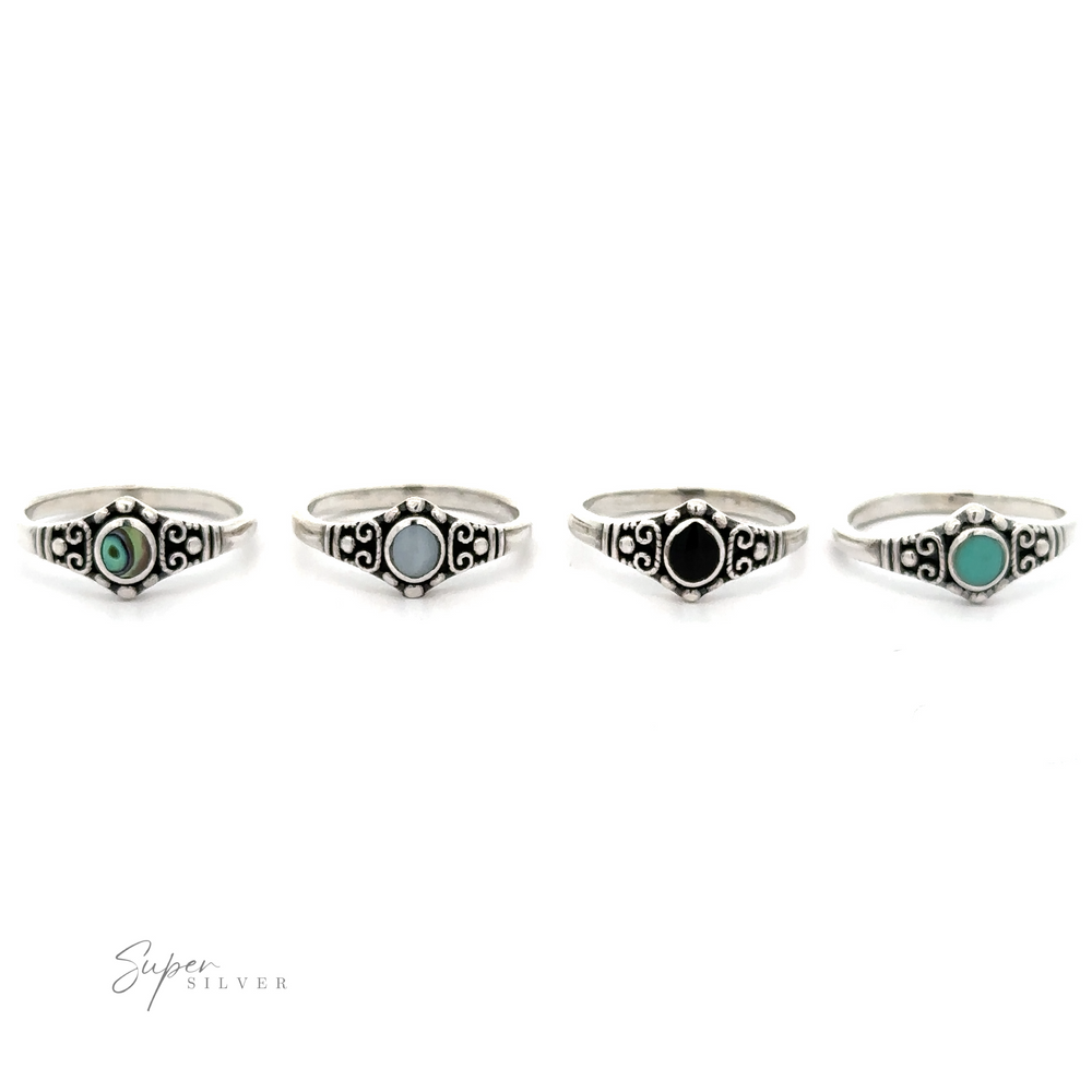
                  
                    A set of four Dainty Inlaid Stone Rings With Silver Beads and Swirls with vintage charm and inlaid turquoise stones.
                  
                