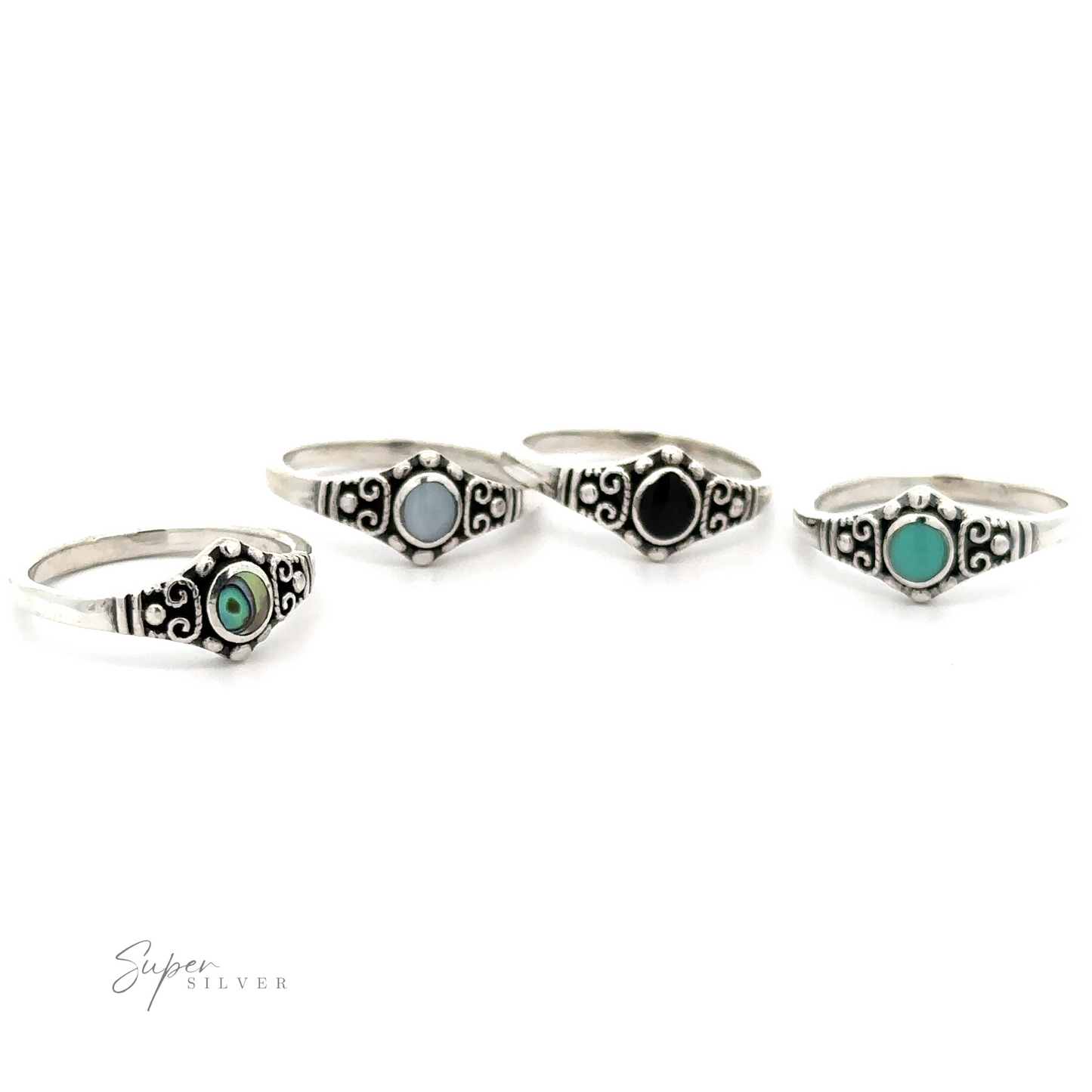 A set of four Dainty Inlaid Stone Rings With Silver Beads and Swirls featuring an antiqued finish.