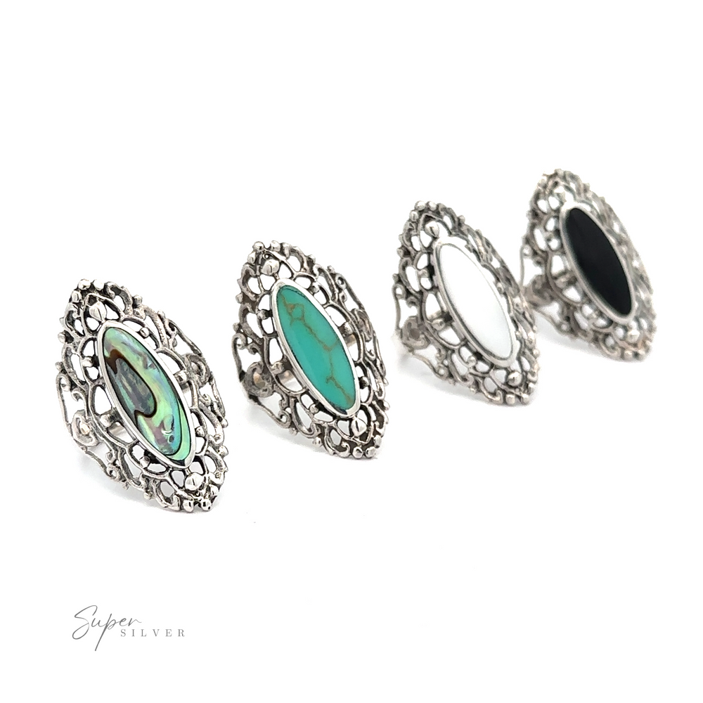A set of four silver Filigree Shield Rings with Inlaid Stones featuring a filigree pattern.