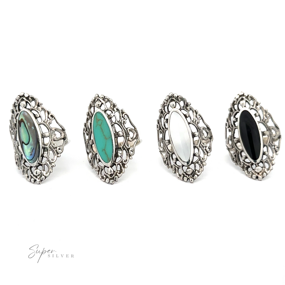 A set of four Filigree Shield Rings with Inlaid Stones.
