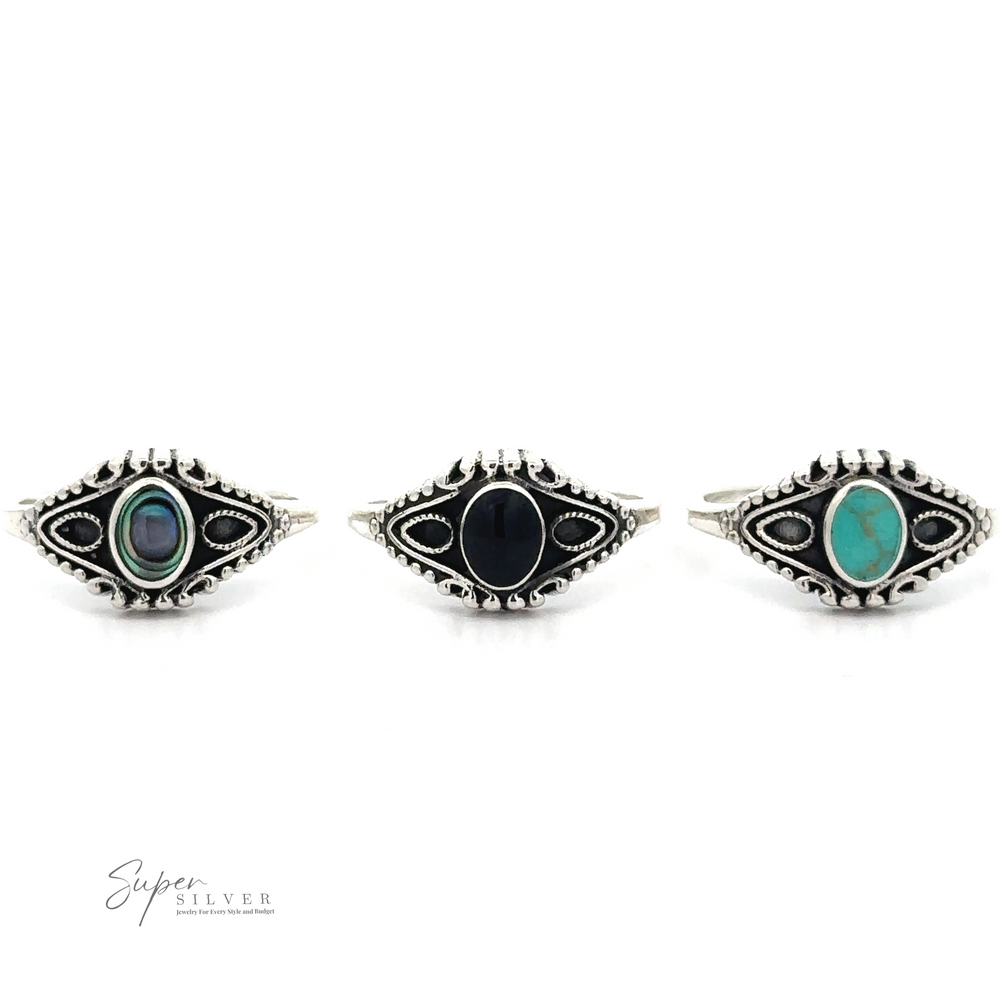 
                  
                    Three intricately designed Vintage Style Rings With Inlaid Oval Stone, crafted from .925 Sterling Silver, each featuring a different inlaid stone: abalone, black onyx, and turquoise. The logo "Super Silver" is at the bottom left corner.
                  
                