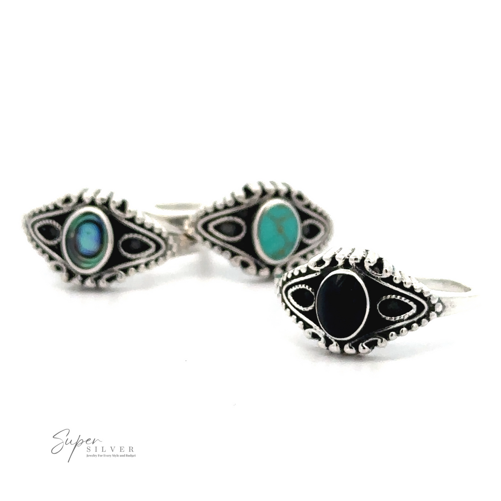 Three silver rings with intricate designs, each featuring a different inlaid stone: one black, one turquoise, and one in blue and green. Crafted from .925 Sterling Silver, these Vintage Style Rings With Inlaid Oval Stone showcase the "Super Silver" logo in the lower left corner.