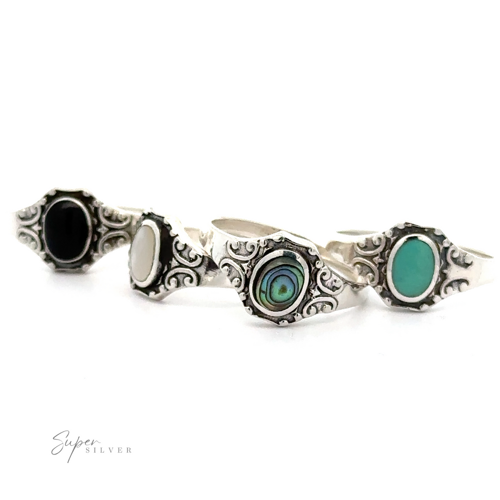A set of four Oval Inlay Stone Rings with Antiqued Filigree Design.