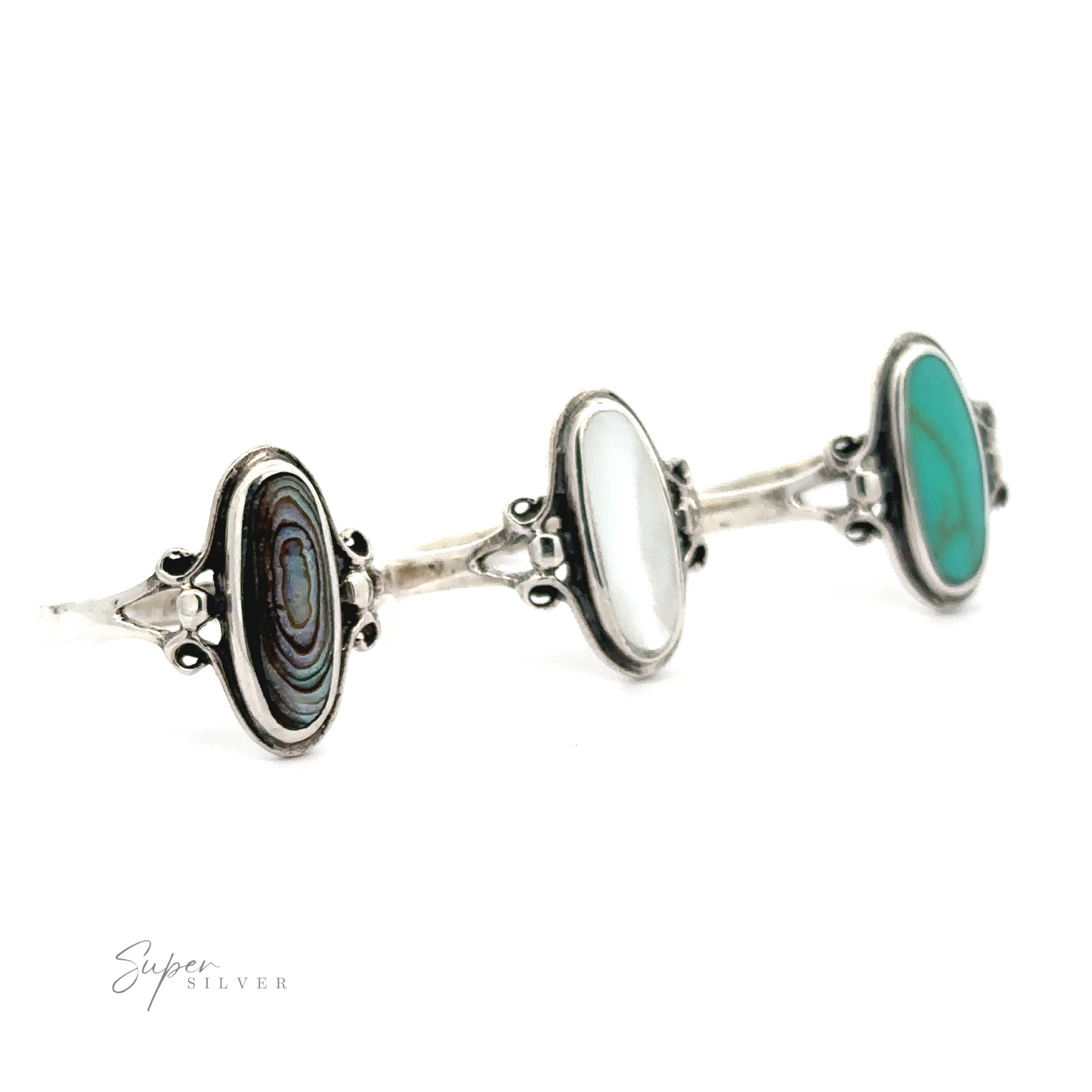 Three sterling silver rings with inlaid green and the Oval Turquoise Ring.
