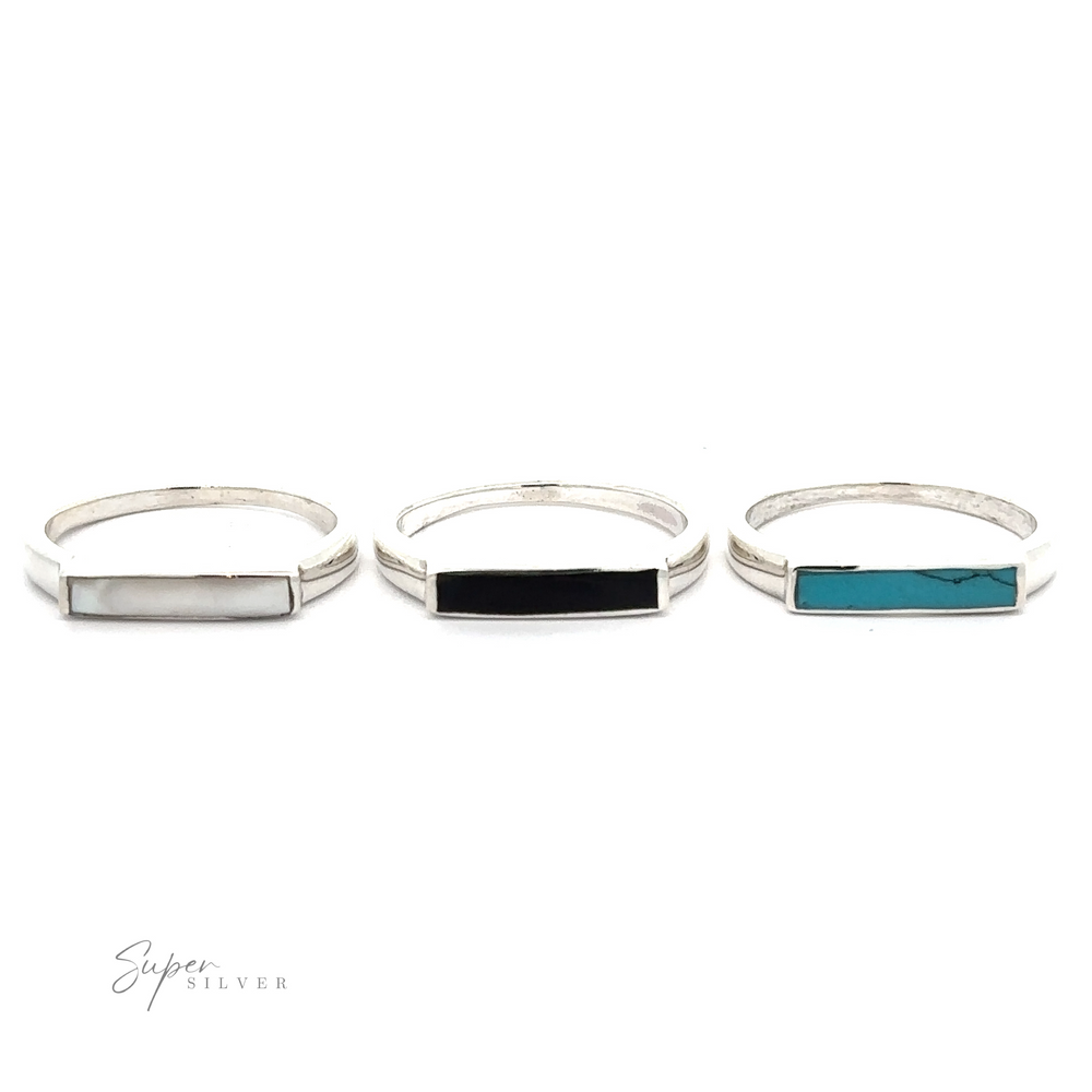 
                  
                    Three Inlay Stone Rectangle Signet Rings with inlaid stones of different colors displayed on a white background.
                  
                