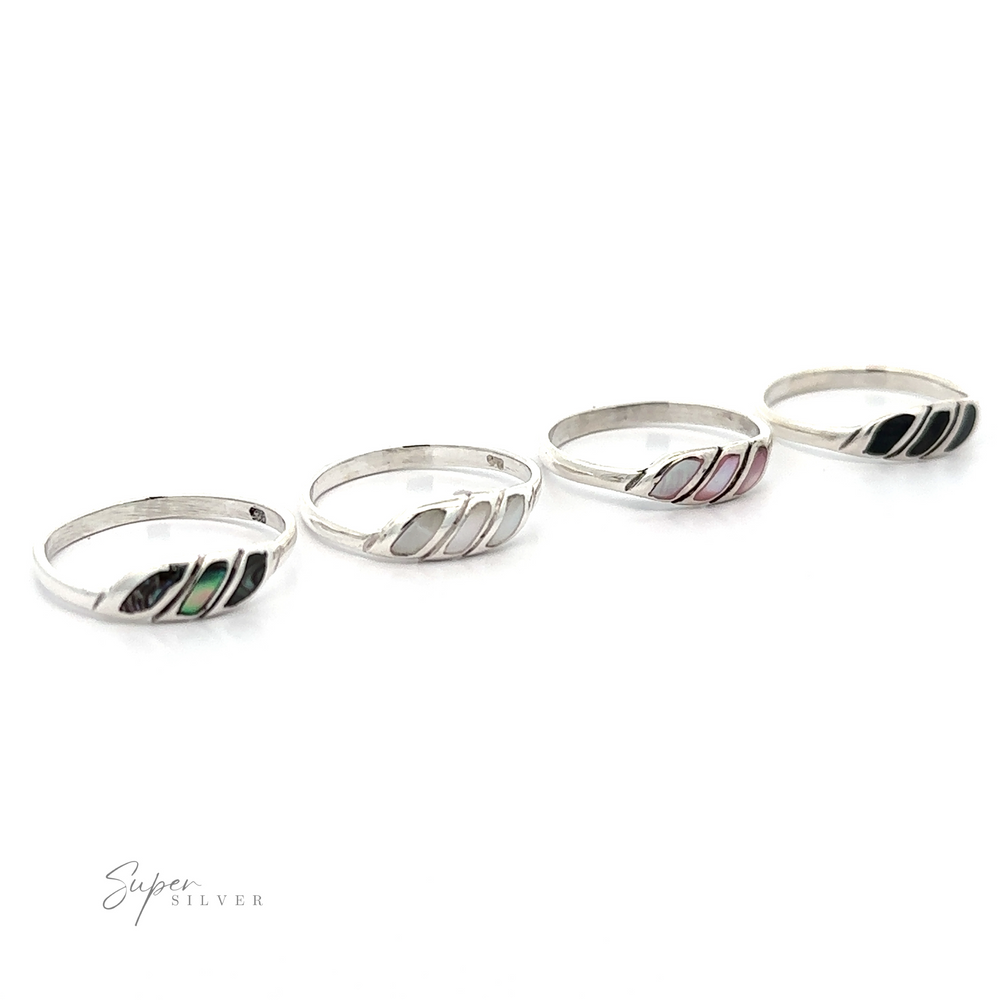 Four Dainty Inlay Stone Twist Rings with varying black line patterns on a white background exude a minimalist marvel.