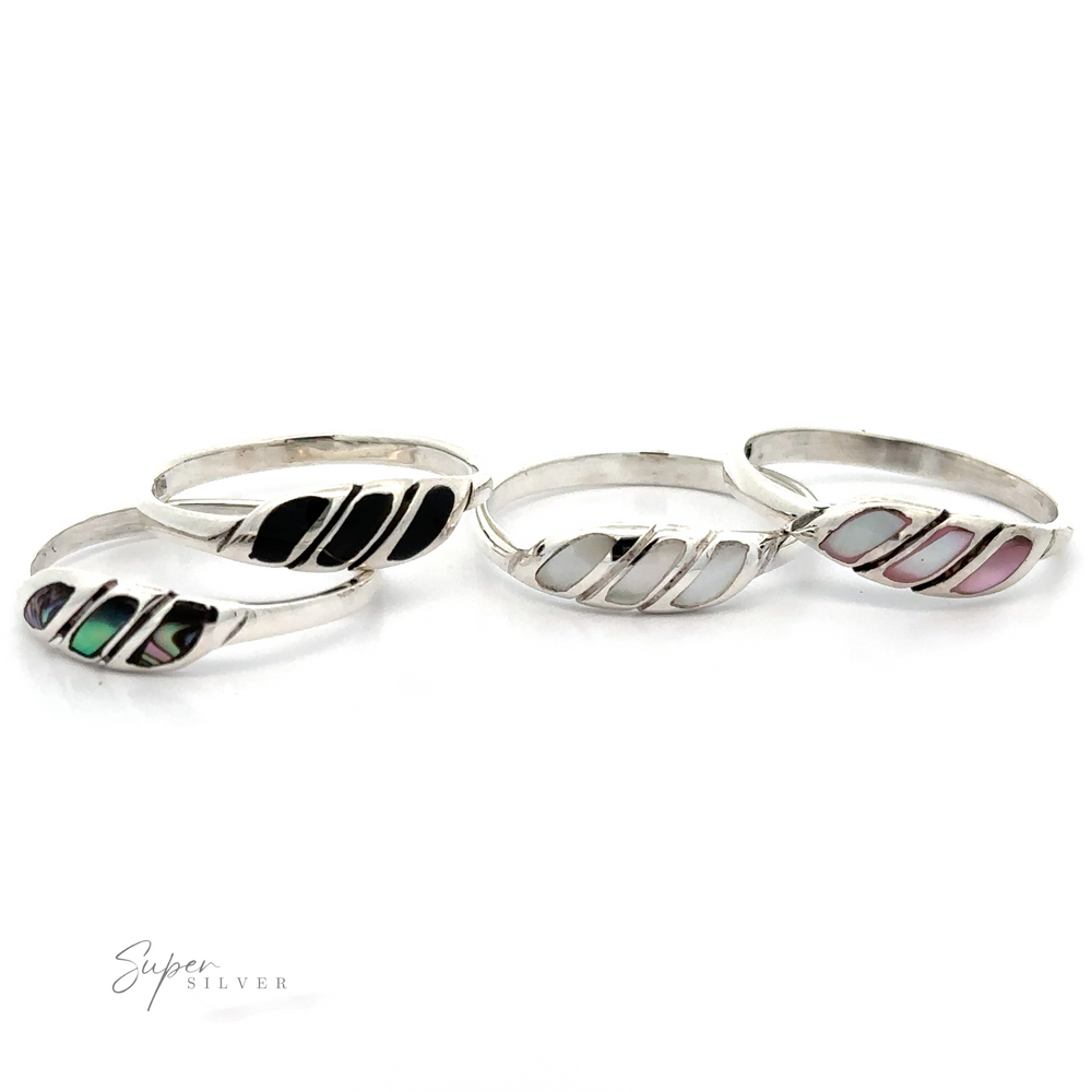 A collection of Dainty Inlay Stone Twist Rings on a white background.