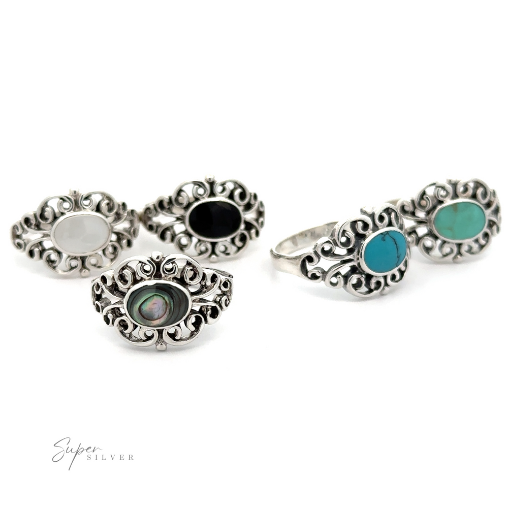 
                  
                    A vintage pair of Victorian Filigree Inlay Stone Rings with black and turquoise stones.
                  
                